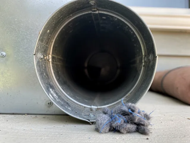 Southbury Dryer Vent Cleaning technician using specialized equipment to clear severe dryer vent blockage in Southbury